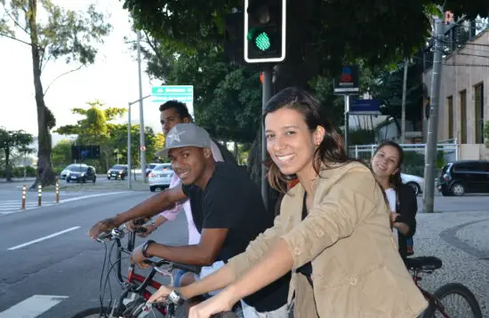 A group of cyclists patiently waiting at a traffic light in Ipanema during a city bike tour