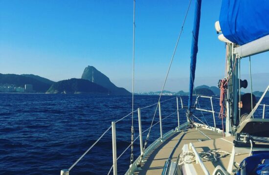 View from the deck of a sailboat in Guanabara Bay, with Rio de Janeiro's Christ the Redeemer in the distance